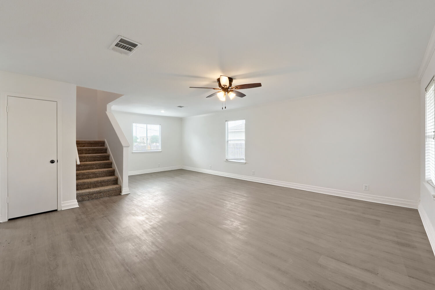 184 Unity Kyle, TX 78640 - Photo 2 of 11 an empty room with wooden floor fan and windows