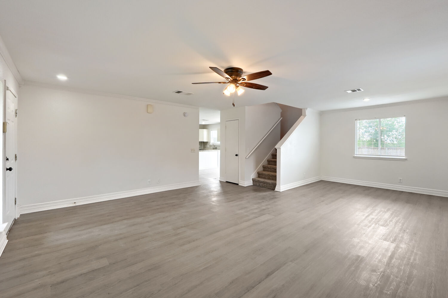 184 Unity Kyle, TX 78640 - Photo 3 of 11 Spacious room featuring light-toned flooring, a ceiling fan with integrated lighting, and a window providing natural light