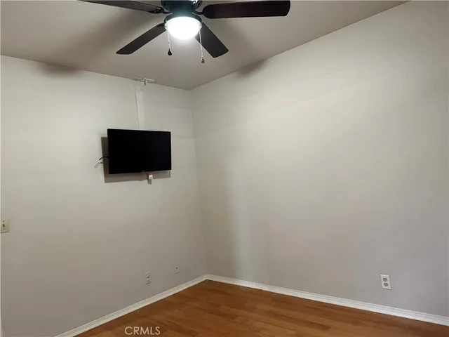 a view of a livingroom with wooden floor and chandelier