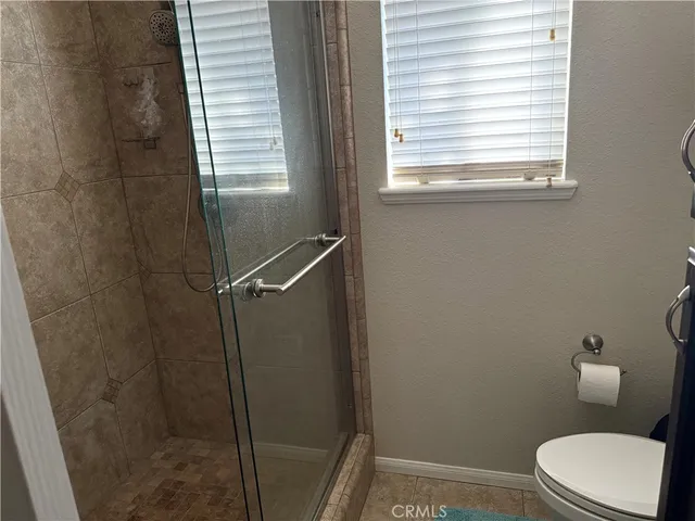 a white toilet sitting next to a window