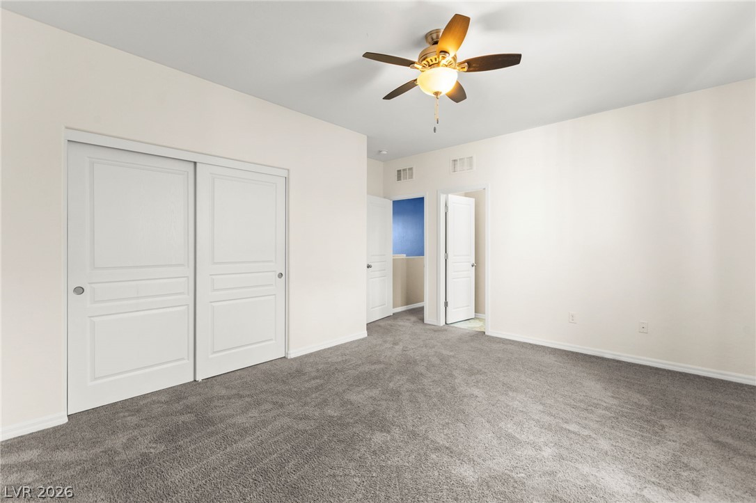 11048 Prairie Grove Road Las Vegas, NV 89179 - Photo 63 of 75 A well-lit bedroom provides comfort with soft carpeting and a ceiling fan.