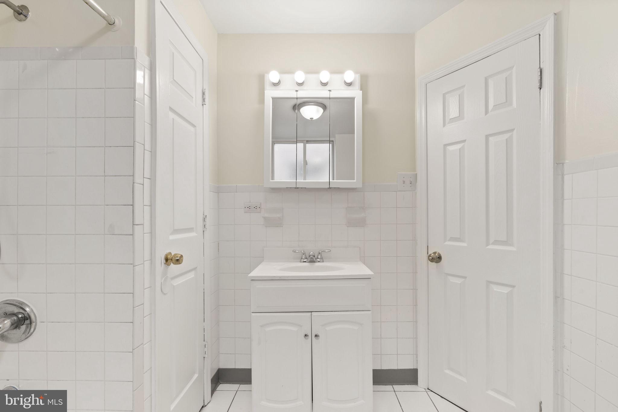 2246 South Hicks Street Philadelphia, PA 19145 - Photo 13 of 26 a bathroom with a sink and a mirror
