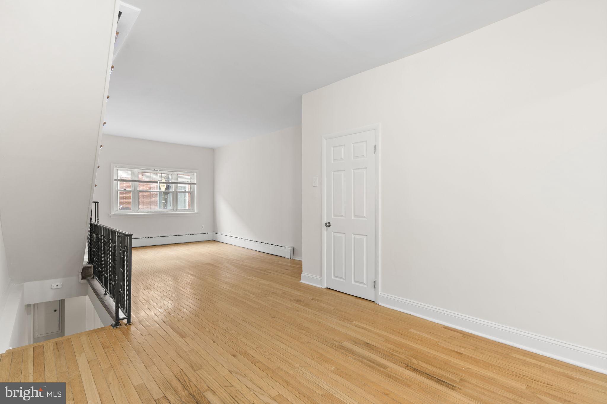 2246 South Hicks Street Philadelphia, PA 19145 - Photo 5 of 26 an empty room with wooden floor and windows