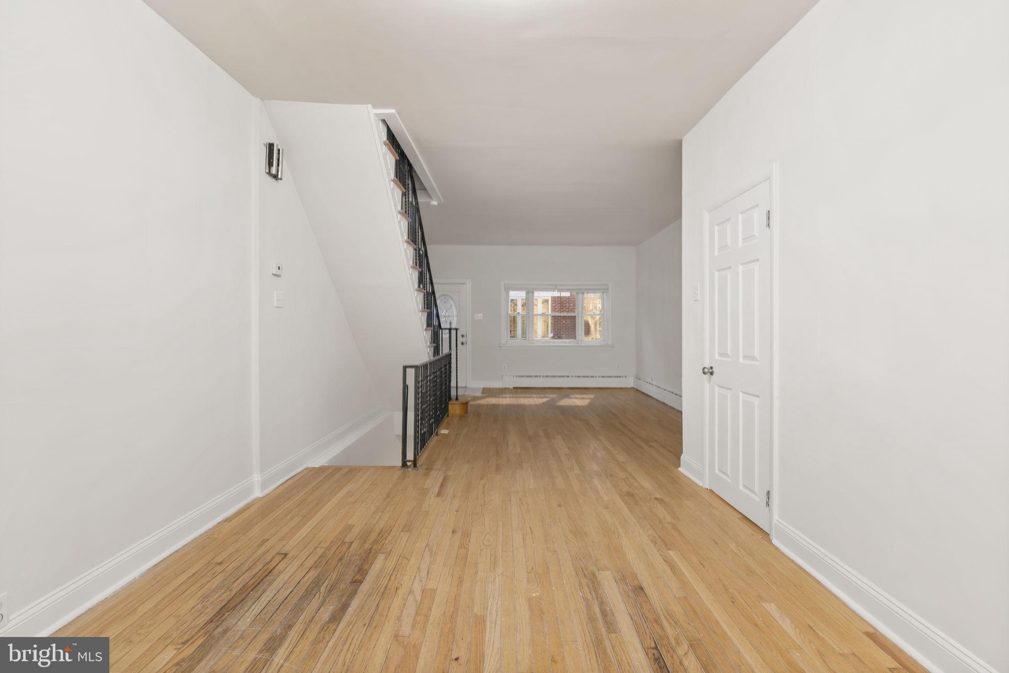 2246 South Hicks Street Philadelphia, PA 19145 - Photo 6 of 26 an empty room with wooden floor and windows