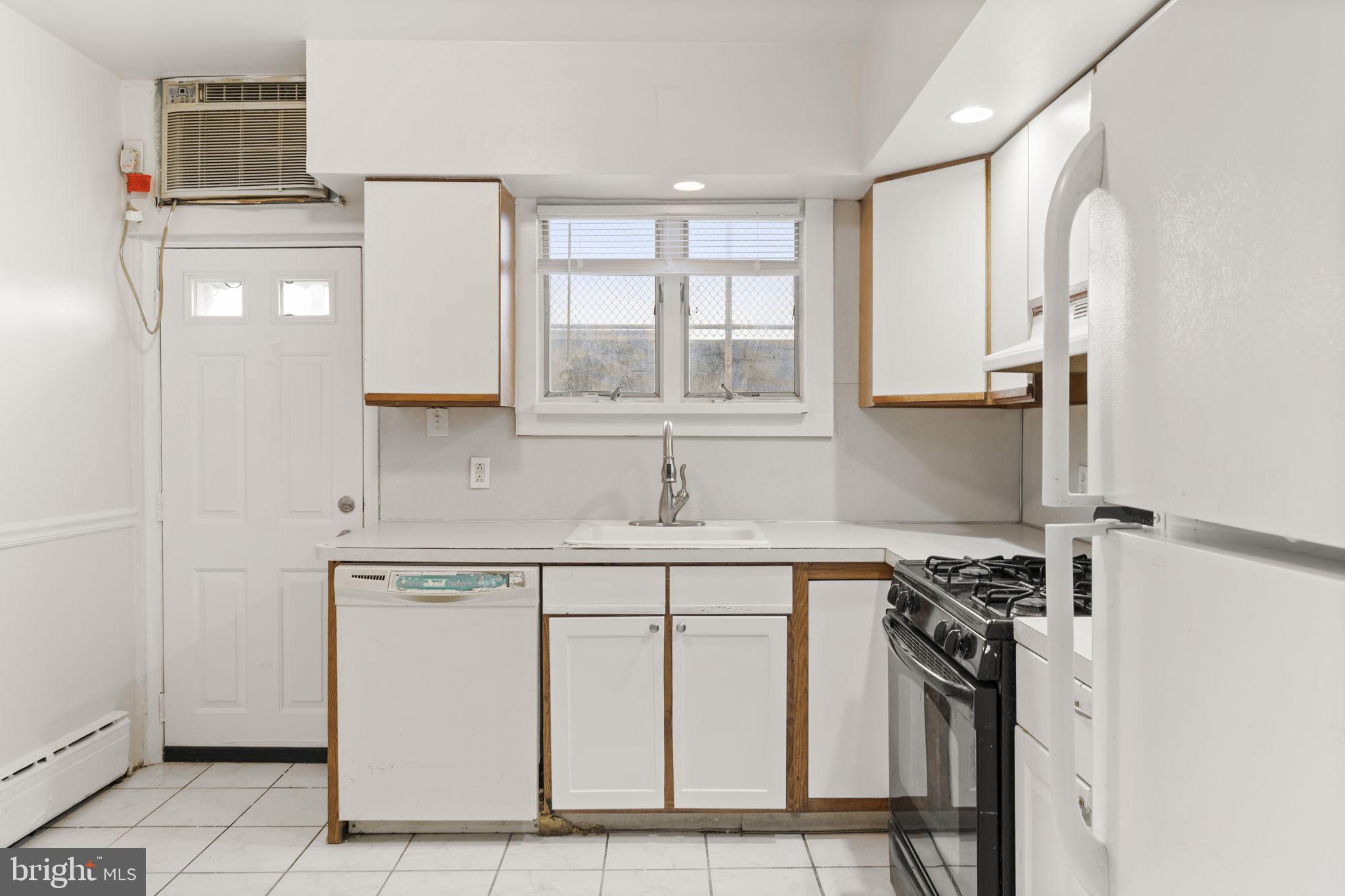 2246 South Hicks Street Philadelphia, PA 19145 - Photo 9 of 26 a kitchen with a sink cabinets and window