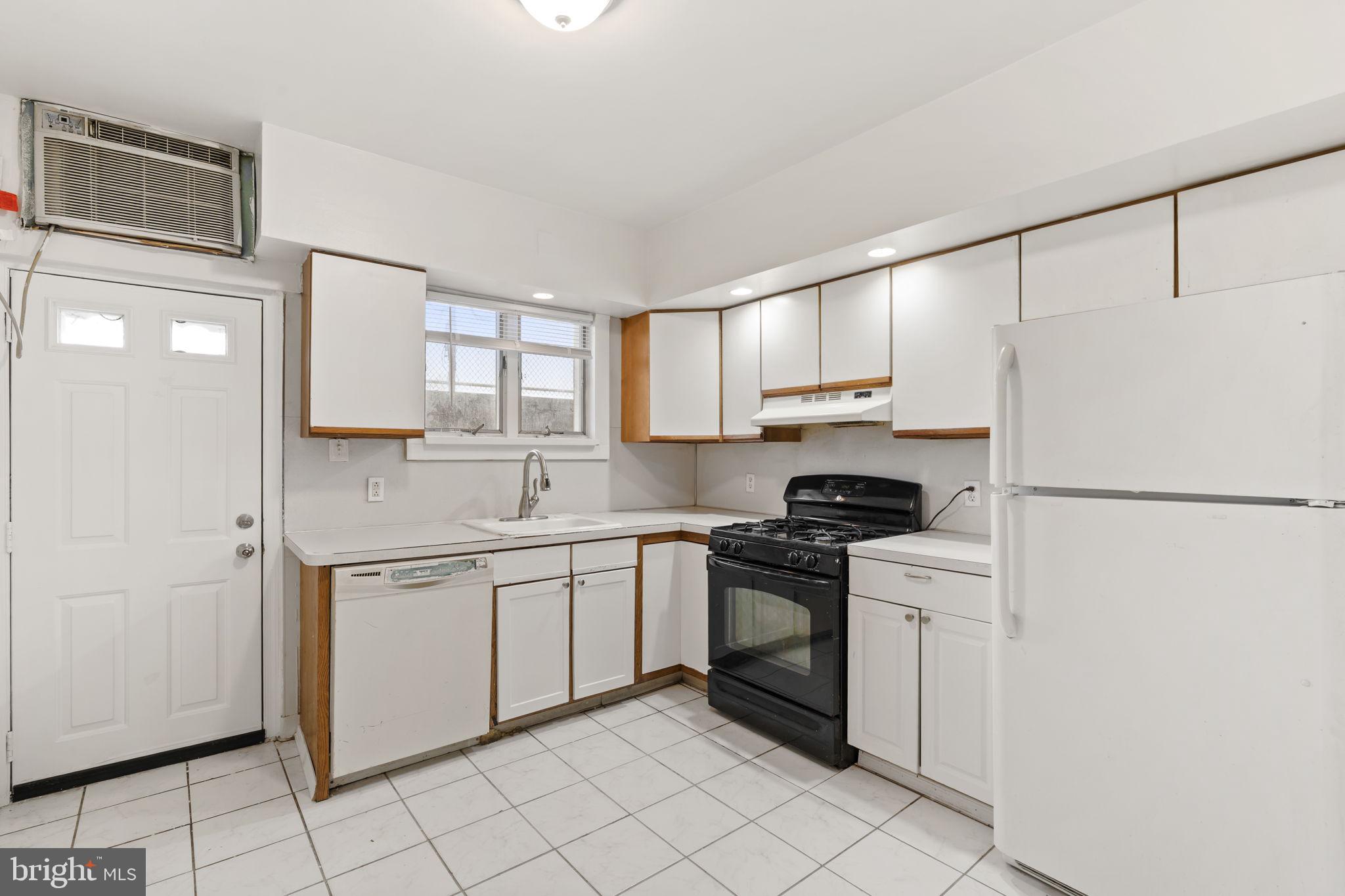 2246 South Hicks Street Philadelphia, PA 19145 - Photo 10 of 26 a kitchen with granite countertop cabinets stainless steel appliances and a sink