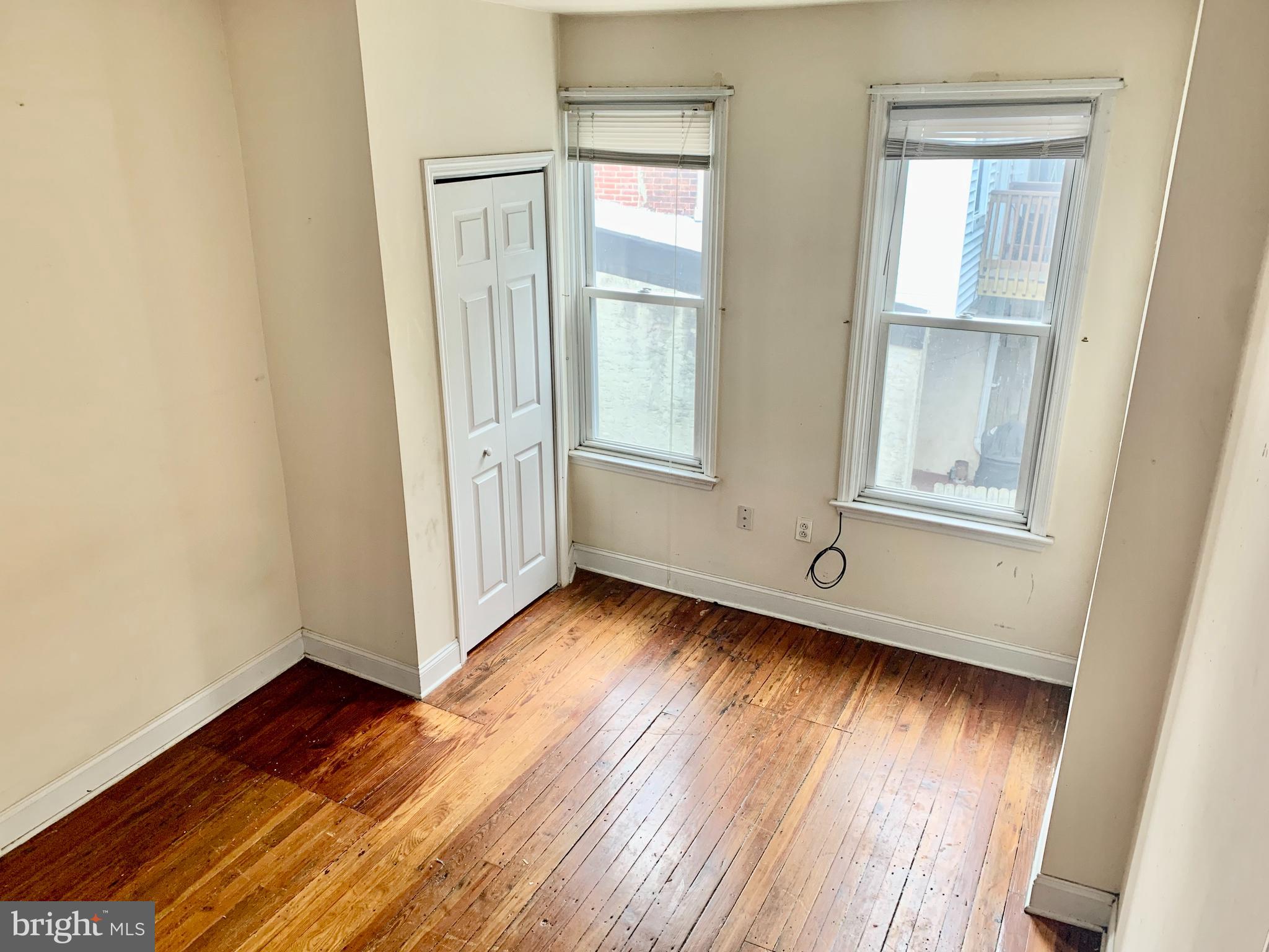 4217 Ridge Avenue, Unit 3 Philadelphia, PA 19129 - Photo 13 of 16 an empty room with wooden floor and windows