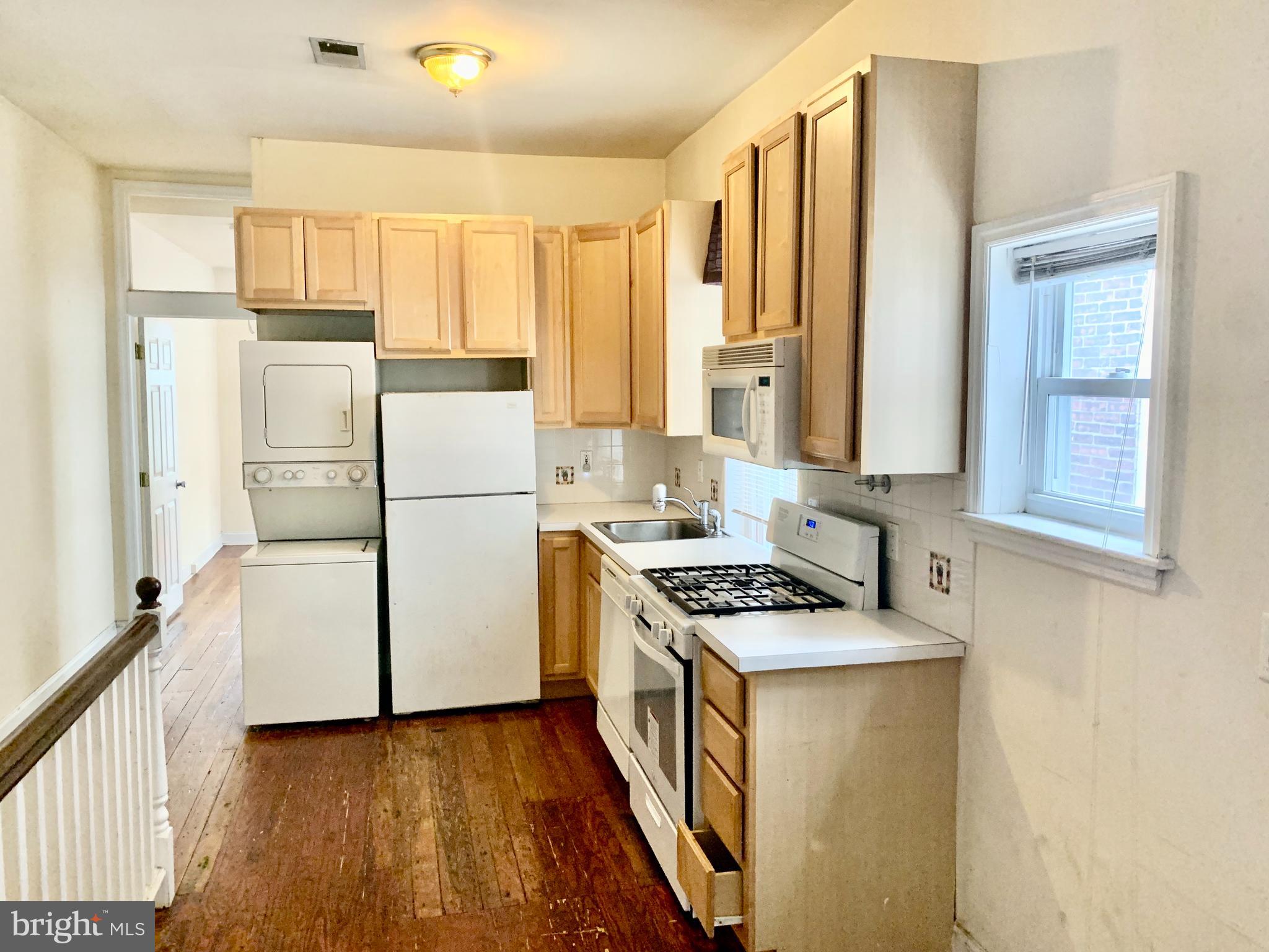 4217 Ridge Avenue, Unit 3 Philadelphia, PA 19129 - Photo 2 of 16 a kitchen with a refrigerator a sink and a stove