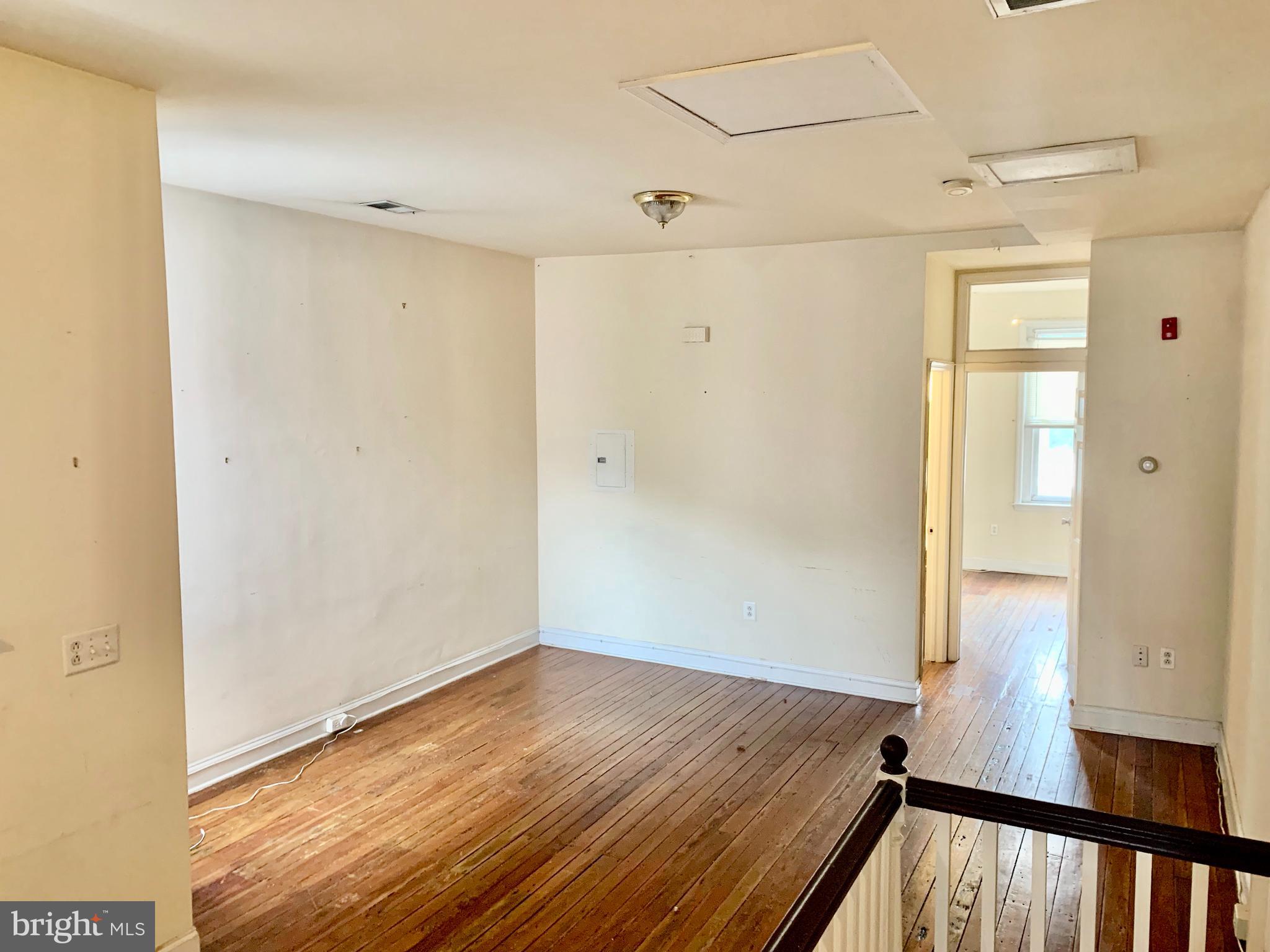 4217 Ridge Avenue, Unit 3 Philadelphia, PA 19129 - Photo 5 of 16 a view of a room with wooden floor and stairs