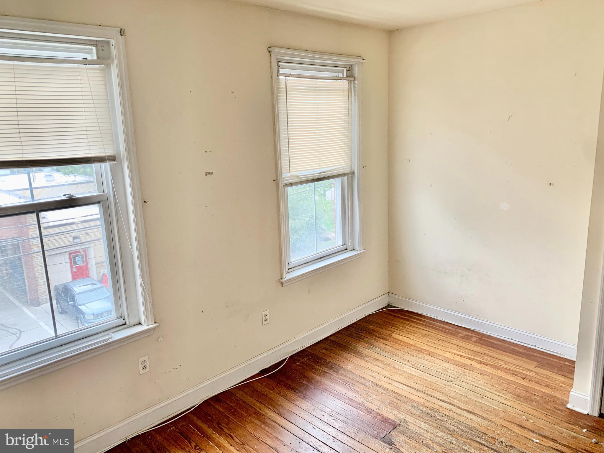 4217 Ridge Avenue, Unit 3 Philadelphia, PA 19129 - Photo 6 of 16 an empty room with wooden floor and windows