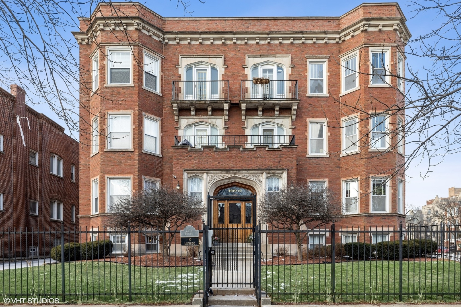 a front view of a residential apartment building with a yard