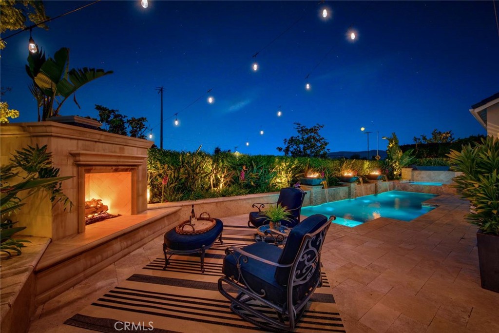 a outdoor living space with patio furniture and a fireplace
