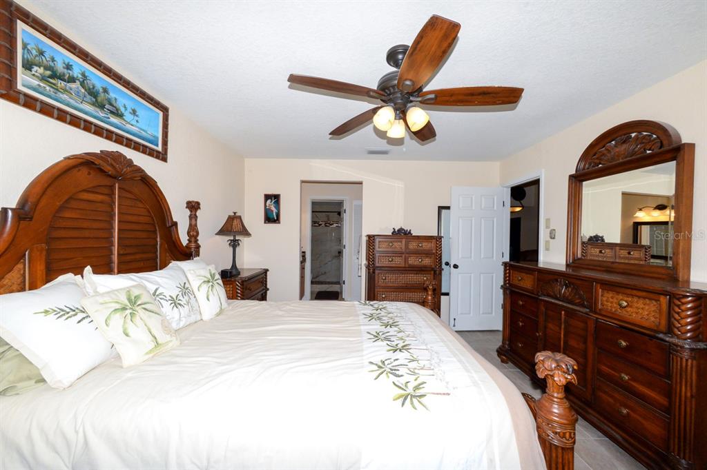 335 Coldeway Drive, Unit F21 Punta Gorda, FL 33950 - Photo 28 of 45 a bedroom with a bed and a chandelier
