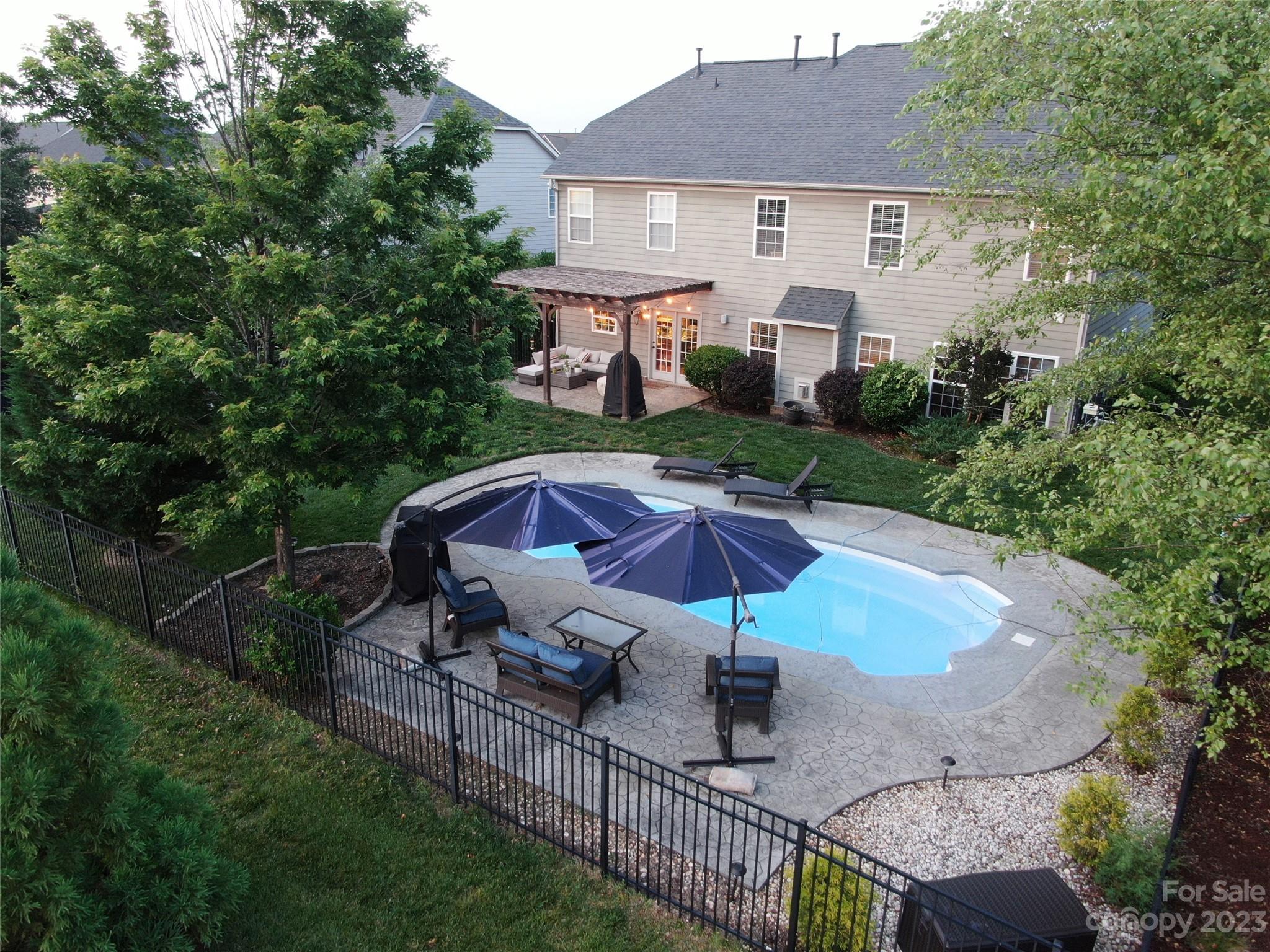 3004 Potomac Road Indian Trail, NC 28079 - Photo 26 of 31 a view of a patio with chairs under an umbrella