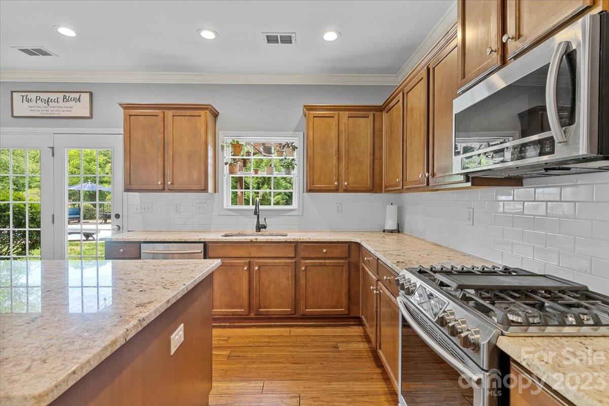3004 Potomac Road Indian Trail, NC 28079 - Photo 5 of 31 a kitchen with stainless steel appliances granite countertop a stove a sink and a microwave