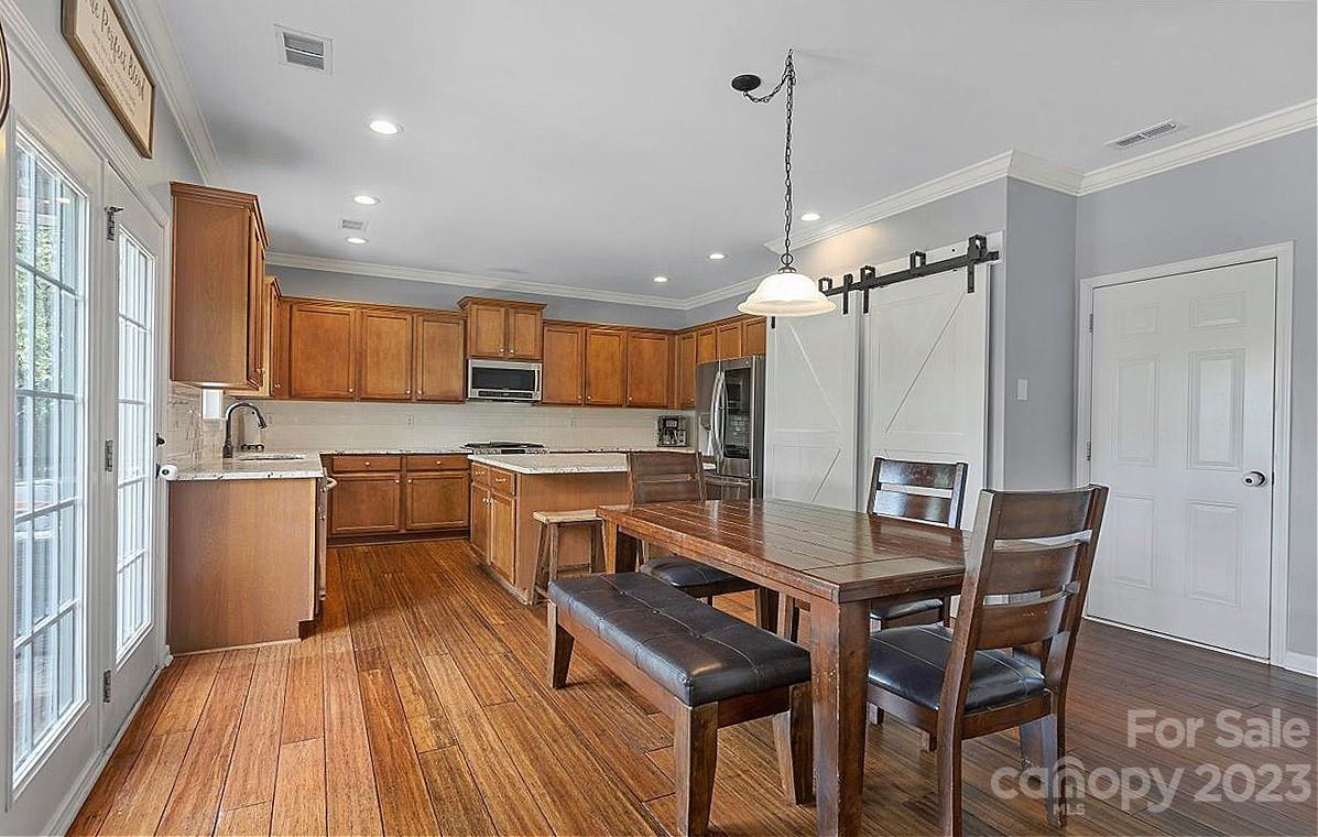 3004 Potomac Road Indian Trail, NC 28079 - Photo 6 of 31 a kitchen with a table chairs refrigerator and microwave