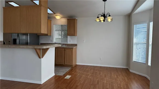 a view of a kitchen with a sink and dishwasher wooden floor
