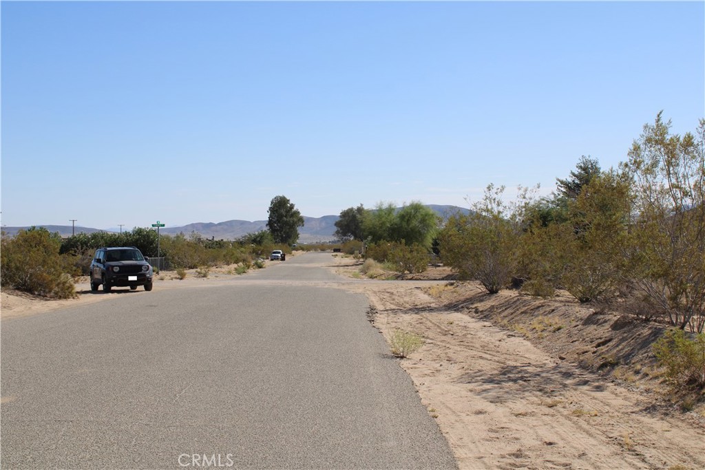 63480 Walpi Drive Joshua Tree, CA 92252 - Photo 7 of 13 a view of a road with a building in the background
