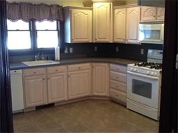 156 Marion Road Rochester, MA 02770 - Photo 8 of 23 a kitchen with granite countertop white cabinets and window