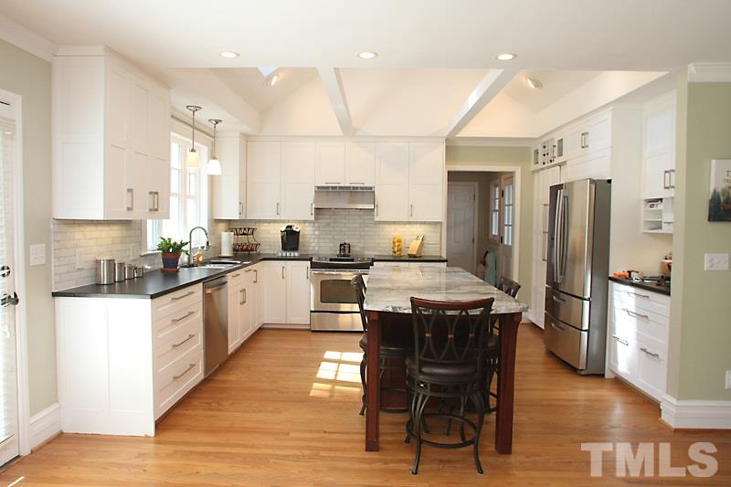 6308 Wynbrook Way Raleigh, NC 27612 - Photo 2 of 21 a kitchen with stainless steel appliances granite countertop a refrigerator a stove a sink a dining table and chairs