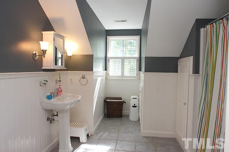 6308 Wynbrook Way Raleigh, NC 27612 - Photo 13 of 21 a bathroom with a sink and a mirror