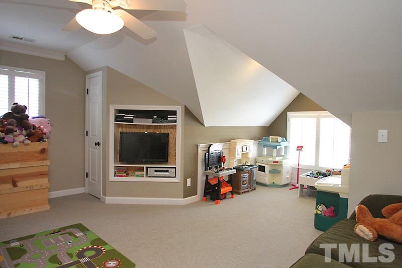 6308 Wynbrook Way Raleigh, NC 27612 - Photo 16 of 21 a view of a livingroom with furniture and a flat screen tv