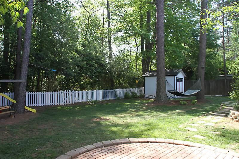 6308 Wynbrook Way Raleigh, NC 27612 - Photo 20 of 21 a backyard of a house with lots of green space and fountain