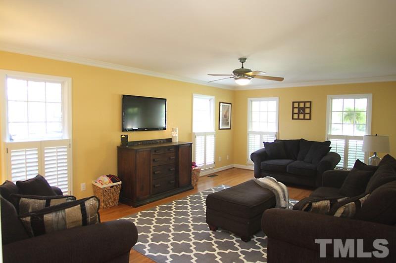 6308 Wynbrook Way Raleigh, NC 27612 - Photo 8 of 21 a living room with furniture and a flat screen tv
