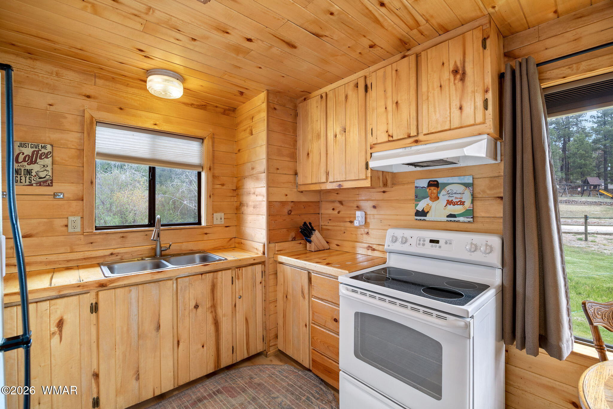 85 Main Street Greer, AZ 85927 - Photo 33 of 55 a kitchen with granite countertop white cabinets and white appliances