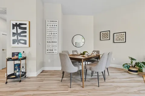 a view of a dining room with furniture and wooden floor
