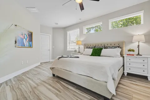 a bedroom with a bed and painting on the wall