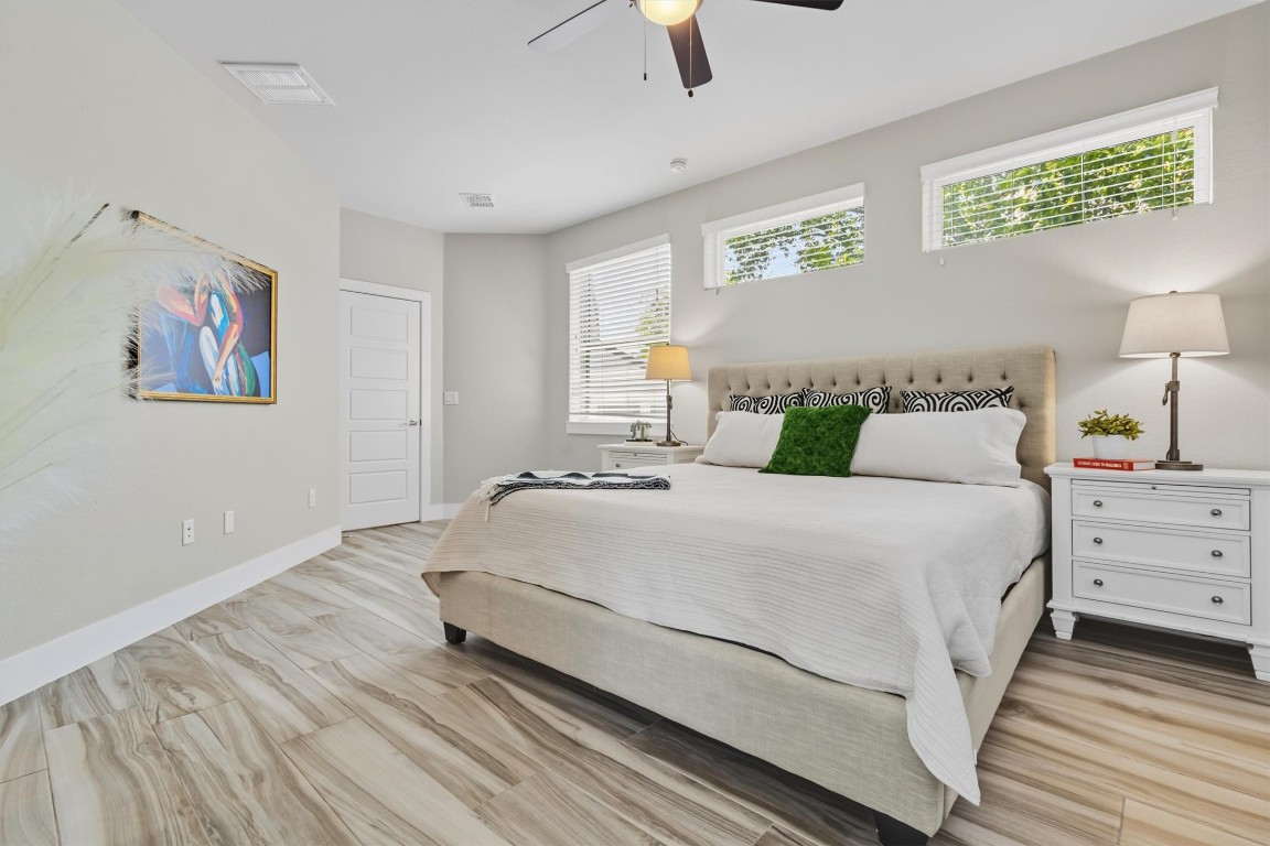 5609 Tura Lane, Unit A Austin, TX 78721 - Photo 20 of 39 a bedroom with a bed and painting on the wall