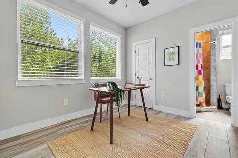 a view of a livingroom with wooden floor and a window