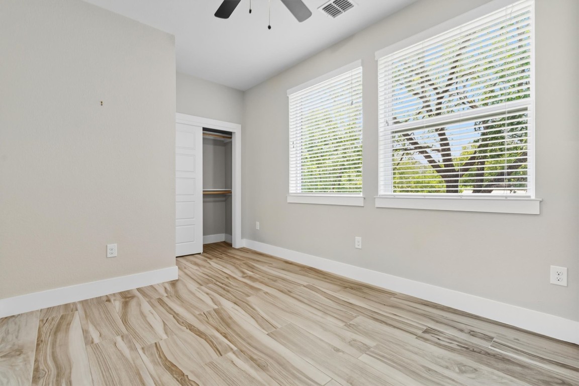 5609 Tura Lane, Unit A Austin, TX 78721 - Photo 26 of 39 a view of an empty room with wooden floor and a window