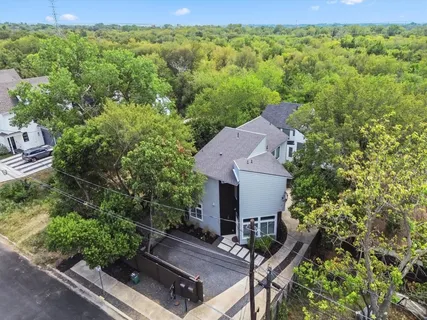 an aerial view of a house with a yard