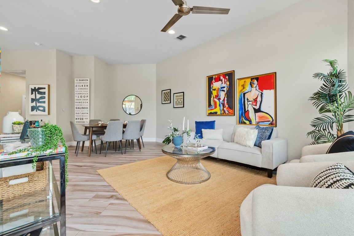 5609 Tura Lane, Unit A Austin, TX 78721 - Photo 7 of 39 a living room with furniture a rug and a chandelier