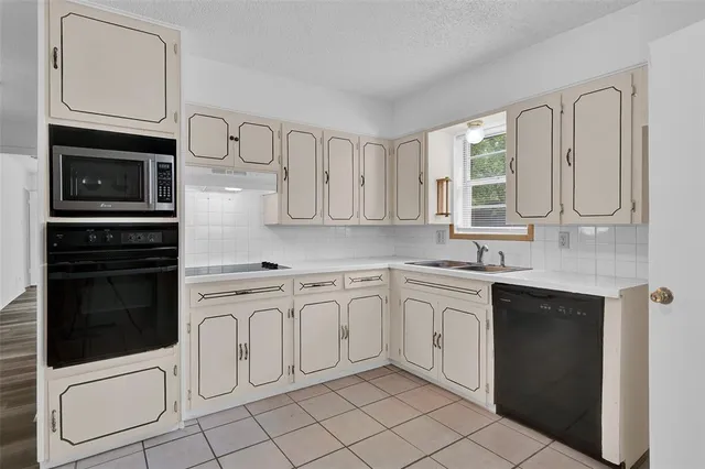a kitchen with stainless steel appliances a stove sink and cabinets