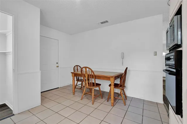 a dining room with furniture and a chandelier