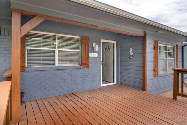 a view of a house with wooden deck