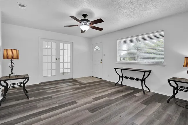 a view of a livingroom with a lounge chair and a window