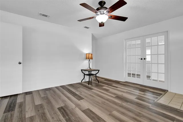 a view of a livingroom with a hardwood floor and a ceiling fan