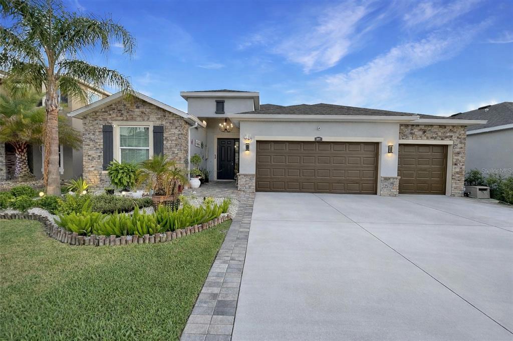 1069 Montgomery Bell Road Wesley Chapel, FL 33543 - Photo 1 of 1 a front view of a house with a yard and garage
