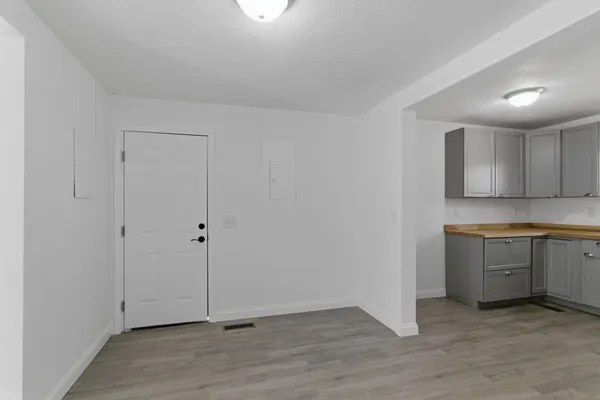 a view of a kitchen with white cabinets