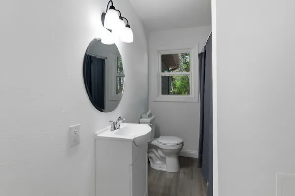 a bathroom with a toilet sink and mirror