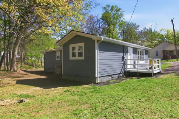 a backyard of a house with a garden and deck