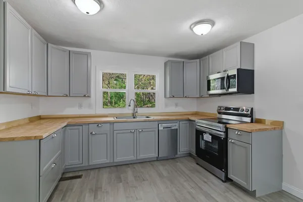 a kitchen with sink stove and microwave
