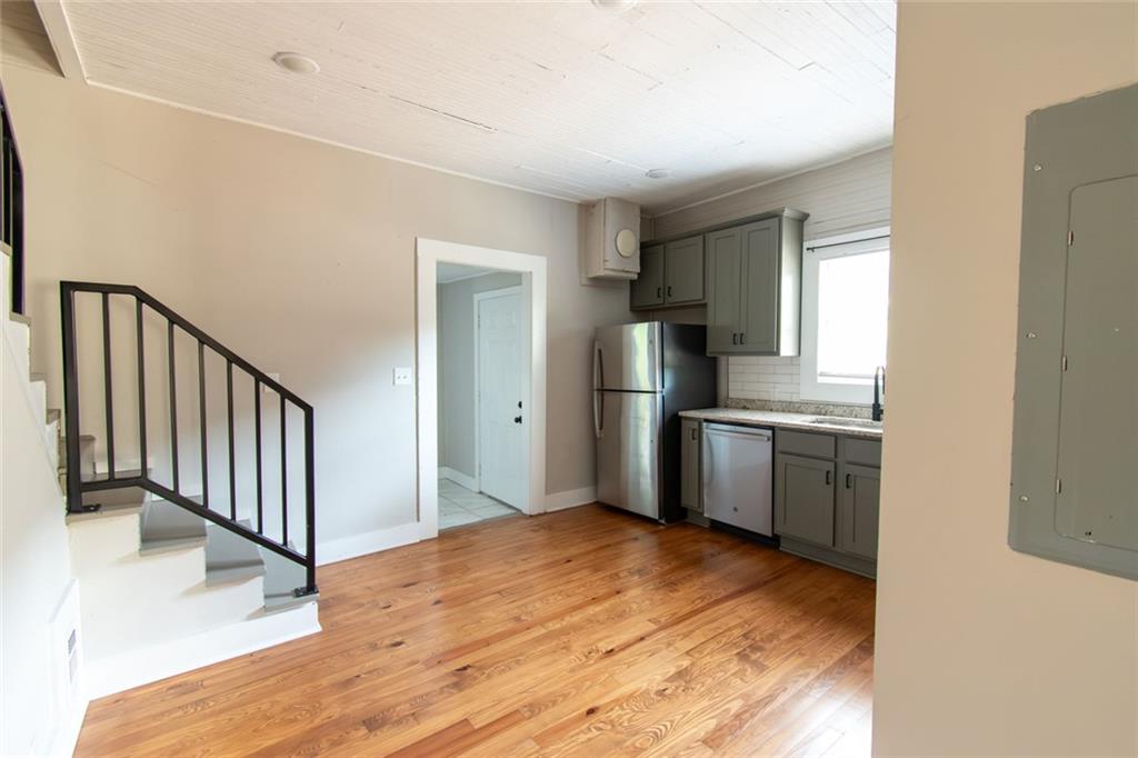 702 Radford Street Monroe, GA 30655 - Photo 29 of 49 a kitchen with refrigerator cabinets and wooden floor