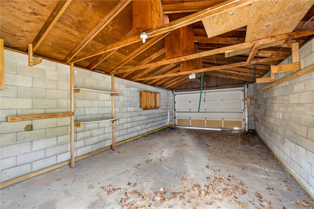 65 2nd Street Slatington, PA 18080 - Photo 46 of 46 This garage offers functional built-in shelving and ample space for vehicles and storage.
