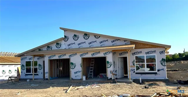 a front view of a house with outdoor seating