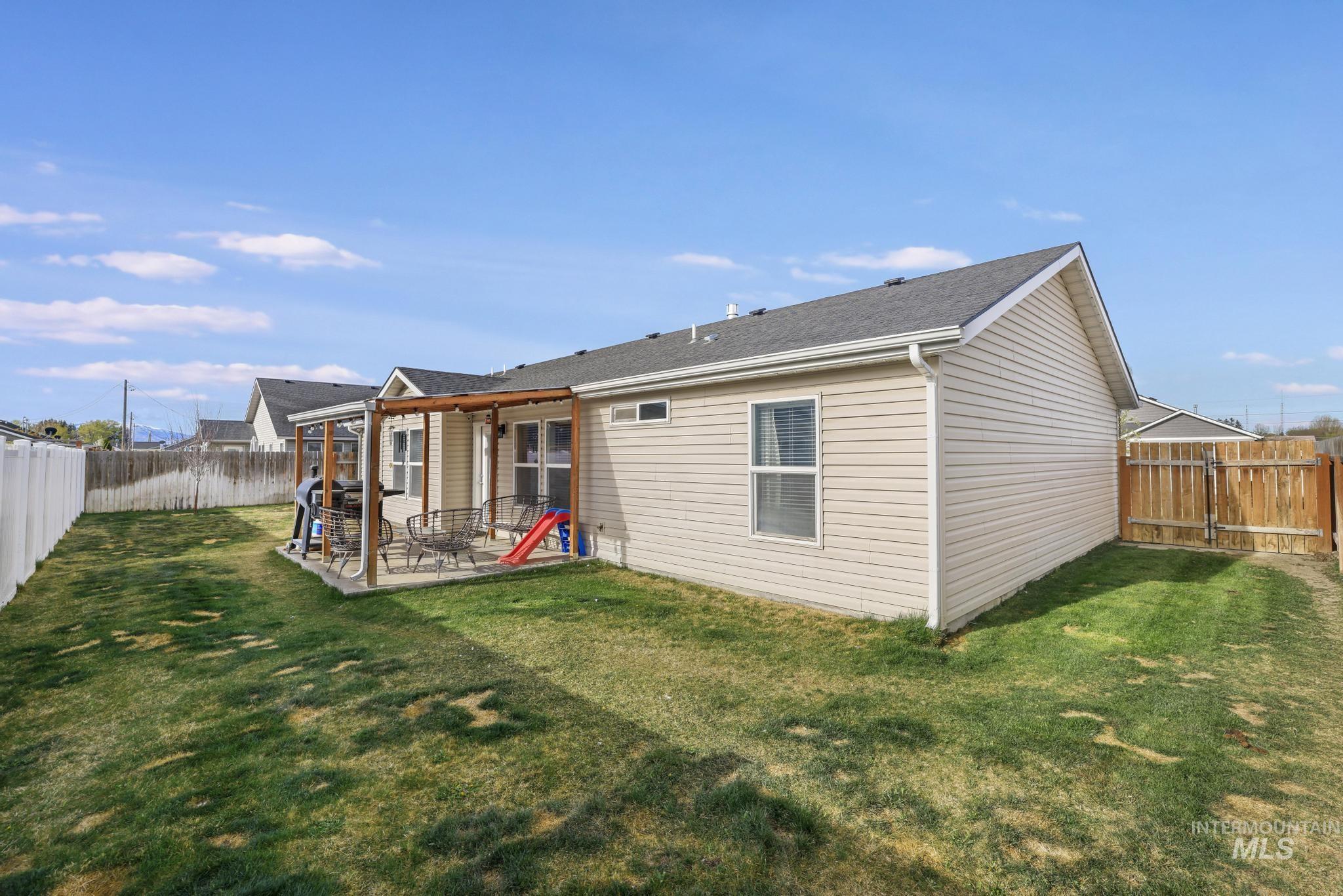 610 South B Street Rupert, ID 83350 - Photo 22 of 26 Back of house with a patio and a fenced backyard